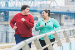 Adult man and woman jogging in the city